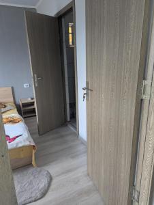 an open door to a bedroom with a bed at Cozy House Corbu in Corbu