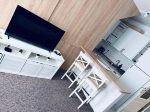 an overhead view of a living room with a television and stool at Apart Aurum B&M in Jáchymov