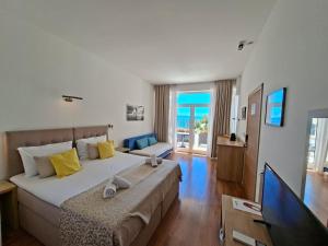 a large bedroom with a large bed and a television at Villa Cascada in Podgora