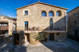 an external view of a stone house with a balcony at Cannn Patllari de Corts I II in Cornellá de Terri