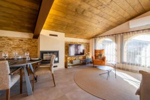 a living room with a table and chairs and a fireplace at Cannn Patllari de Corts I II in Cornellá de Terri