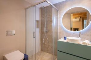 a bathroom with a shower and a toilet and a sink at Cannn Patllari de Corts I II in Cornellá de Terri +37 photos