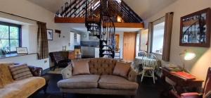a living room with a couch and a table at Stable Lodge in Berwick-Upon-Tweed +21 photos