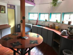 a kitchen with a wooden table in the middle at Chakana Newen Refugio in San Clemente