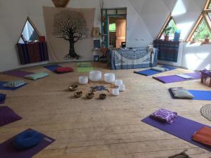 a room with a bunch of yoga mats on the floor at Chakana Newen Refugio in San Clemente