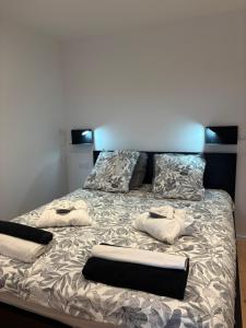 a bed with two pillows on top of it at Studio Cocon & Bulle in La Côte-Saint-André