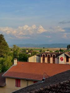 a group of buildings with red roofs and trees at Studio Cocon & Bulle in La Côte-Saint-André