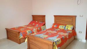 two beds sitting next to each other in a bedroom at Qasr Diana in Marsa Matruh +25 photos