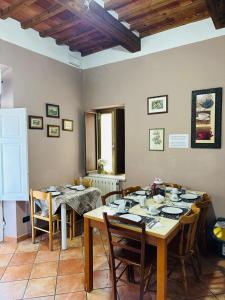 a dining room with two tables and chairs and a table and chairsktop at Affittacamere L'Arancio in Lucca