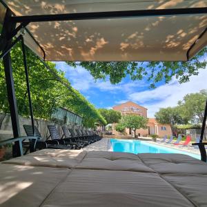 a view of a swimming pool with chairs and a bed at Pansion Bonaca in Srima