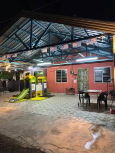 a playground with a slide and a table at Homestay D Makmur UNIT 2 in Mersing