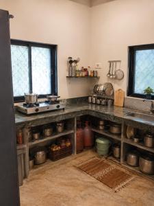 a kitchen with a counter top and a sink at Sahil Private Pool Villa in Alibaug
