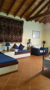 a living room with two beds and a table at The Gallipoli Houses in Eceabat