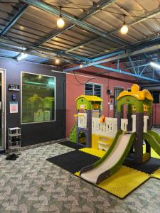 a play room with a slide and a playground at Studio D'Makmur in Mersing