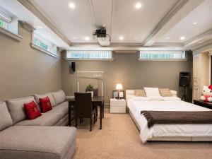 a bedroom with two beds and a couch and a table at Campus Haven Near YVR UBC Downtown in Vancouver +50 photos