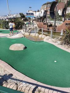 a miniature golf course with a putting green at Summerfields cottage stylish Home in Hollington
