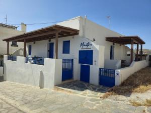 a white building with blue doors on it at Maitos Apartments in Galanádhon