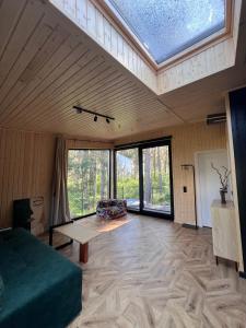 a large room with a large skylight in a house at Connect Cabin - Bungalow Brasov, jacuzzi & forest view in Purcăreni