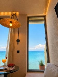 a room with a window with a view of the ocean at Ca' Mare luxury suite in Mesongi +30 photos