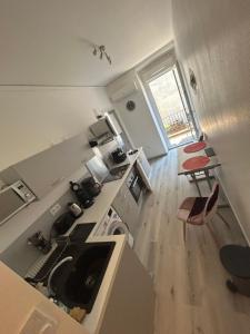 a kitchen with a sink and a stove top oven at Appartement 5 - T2 Meublé 2 étoiles proche des thermes in Vals-les-Bains