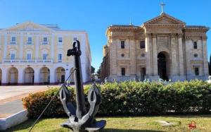 a statue in the grass in front of a building at Apartamentos Lebrero in San Fernando