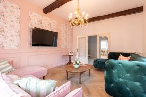 a living room with a couch and a table at L'Apothicaire 2 Chambres - Piscine in Montaigu-Vendée