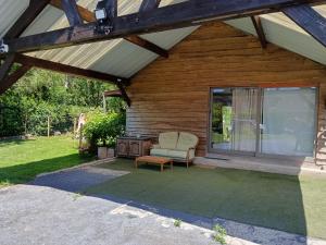 a screened in porch with a chair and a window at L'annexe in Gouy