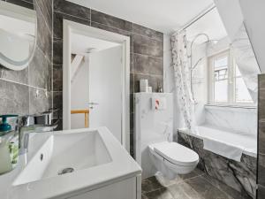 a white bathroom with a sink and a toilet at Auszeit in Goslar +12 photos