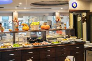 a buffet line with food on display in a restaurant at May park HOTEL in İzmir