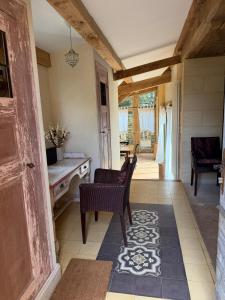 a hallway with a table and chairs in a house at Les Maisons d'Antan 5 étoiles in Saint-Geniès