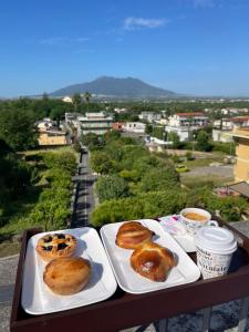 three plates of donuts sitting on a table with a view at Bellosguardo Suites in San Paolo Bel Sito +36 photos