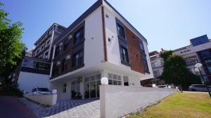a white building on a street with buildings at AC Konaklama in Kuşadası