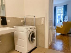 a washer and dryer in a bathroom with a sink at Villa Jahn in Baden
