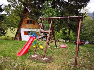 a playground with a slide and a swing at Chata Panorama in Čremošné
