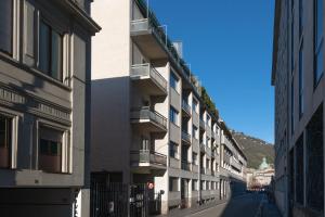 a building with balconies on the side of a street at Marcello's Como Lake in Como