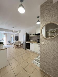 a kitchen and living room with a table and chairs at Holidays font mourrier in Cogolin