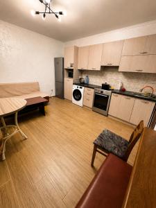 a kitchen with a couch and a table in a room at Дом у Озера in Priozersk