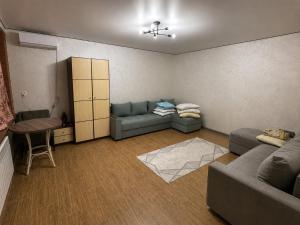 a living room with a couch and a table at Дом у Озера in Priozersk