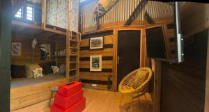 a room with a bunk bed and a bedroom with red boxes at River House superbe vue- vue et accès directe sur la rivière et baignade dans les bassins naturels in Saint-Joseph