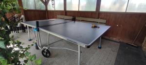 a ping pong table in a room with two chairs at Domki Nad Satwem Mazury D2 in Mrągowo