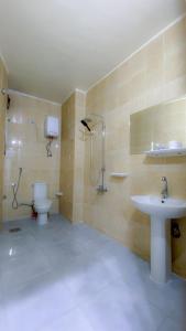 a bathroom with a toilet and a sink at Grand Hotel Qena in Qinā +46 photos