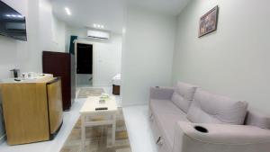 a living room with a couch and a table at Grand Hotel Qena in Qinā