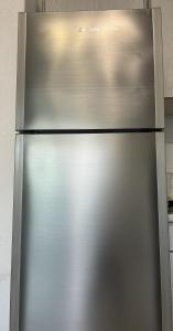 a stainless steel refrigerator in a kitchen at Pefkostalia in Pefkochori +9 photos