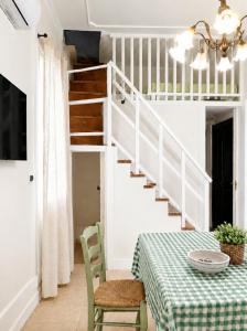 a dining room with a table and a staircase at Terrazza Rossetti in Vasto