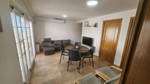 a living room with a table and a couch at Miramar Playa in La Playa de la Torre de Piles
