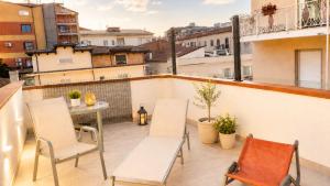 a balcony with two chairs and a table on a building at Terrazza Rossetti in Vasto