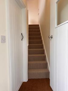 a staircase in a house with a stair case at Hinton Hayloft in Hinton in the Hedges +14 photos