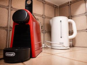 a red appliance sitting on a counter next to a toaster at Bijou Alpina Surlej in Silvaplana