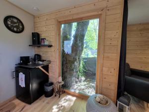 a room with a sliding door to a tree at Tiny House Chimay in Chimay