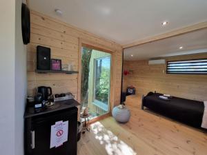 a bedroom with a bed and a television in a room at Tiny House Chimay in Chimay